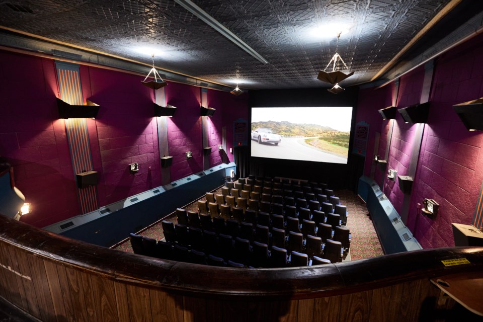 The Wales Theatre in High River sports classic tin ceiling tiles and a balcony overlooking ground-floor seats.