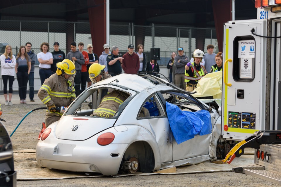 First responders work to free a trapped car crash victim during Operation Prevention in Diamond Valley on May 17, 2023. 