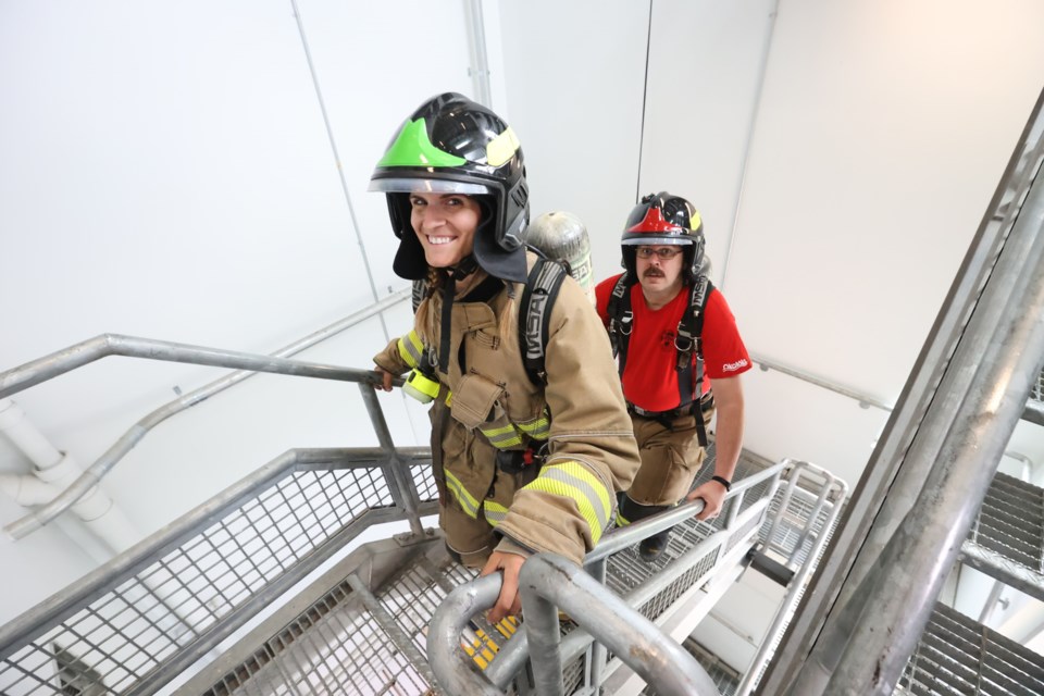 Okotoks firefighters Nicole Byrne and Ryan Kaiser train for the Wellspring Firefighter Stairclimb at Station 2 on May 25, 2023. 