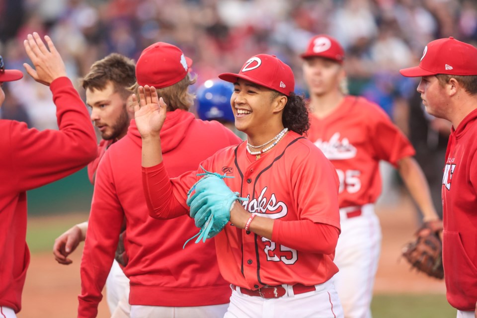 Vic Domingo celebrates with teammates during the Okotoks Dawgs Canada Day game 10-0 victory over the Brooks Bombers at Seaman Stadium on July 1.