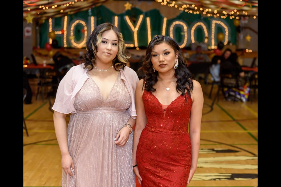 Royelle Daniels, left, and Sara Lefthand pose for a photo before donning their gowns during their graduation ceremony at Chief Jacob Bearspaw Memorial School in Eden Valley on June 26. 