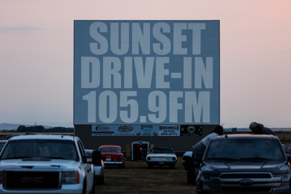 The screen displays the radio frequency for audio before a showing at the Sunset Drive-In on Aug. 5.