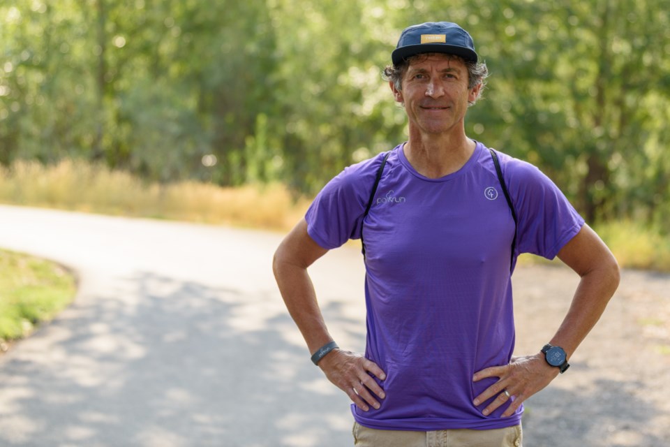 David Alexander stands for a photo on a pathway in Sheep River Park near the Laurie Boyd Bridge in Okotoks on Aug. 16. Alexander is the event director for parkrun in Okotoks.