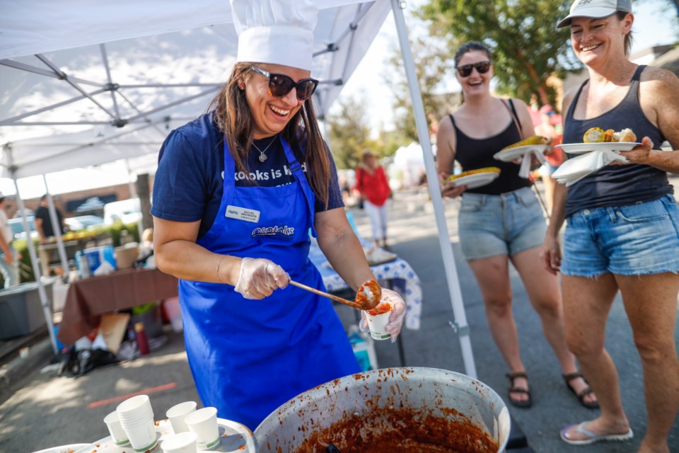 Okotoks Town Councillor Rachel Swendseid serves up the Town's chili during Chilifest & BBQ Showdown in downtown Okotoks on Aug. 26.