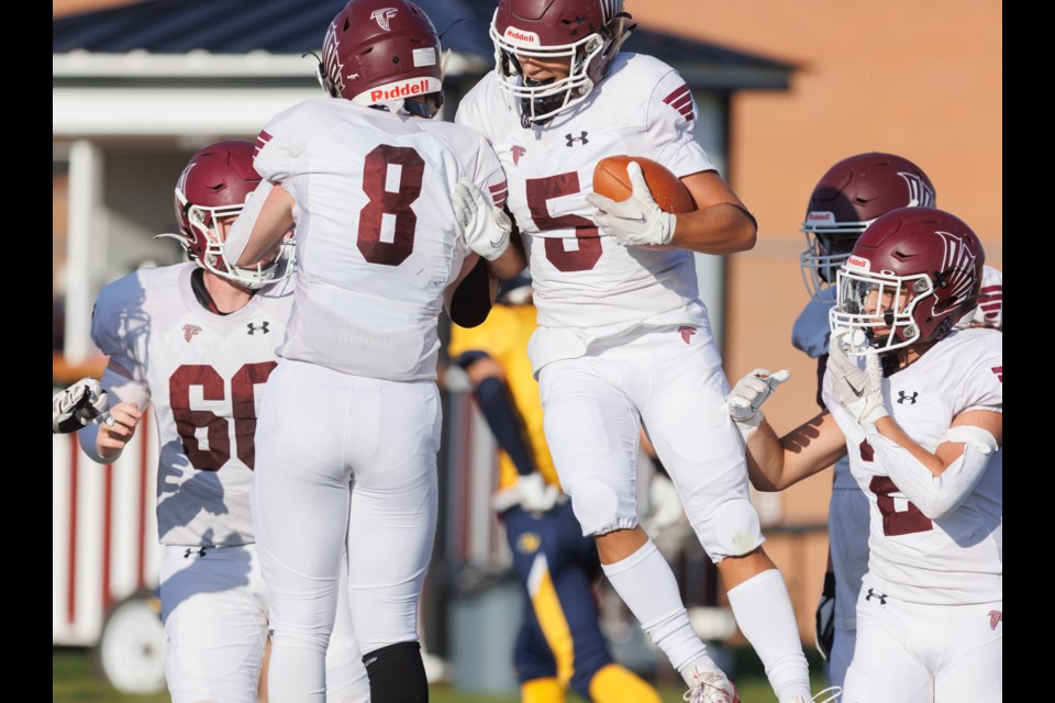 Foothills Falcons Derek Boisvert (8) and Jed Rodriguez (5) celebrate the team’s second touchdown in the 41-0 victory over Red Deer’s Notre Dame Cougars on Sept. 8 at Falcons Field. Foothills improved to 2-0 with the win.