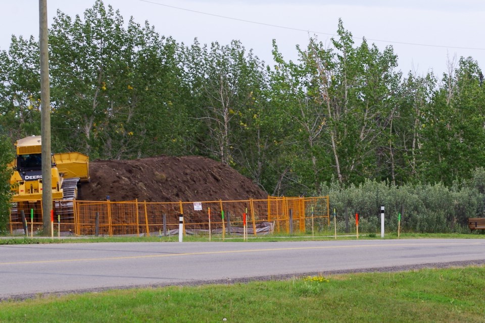 A berm being constructed in connection to remediation work at a historic oil and gas facility in Diamond Valley on Aug. 9.