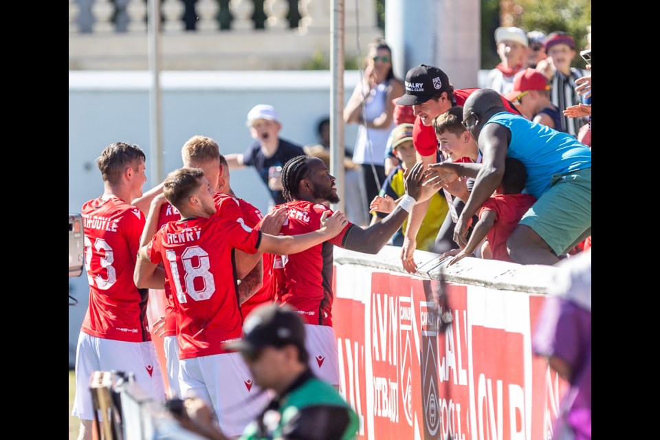 Cavalry FC celebrate the opening goal with supporters during the 2-1 victory over Vancouver FC at Spruce Meadows' ATCO Field on Sept. 16.