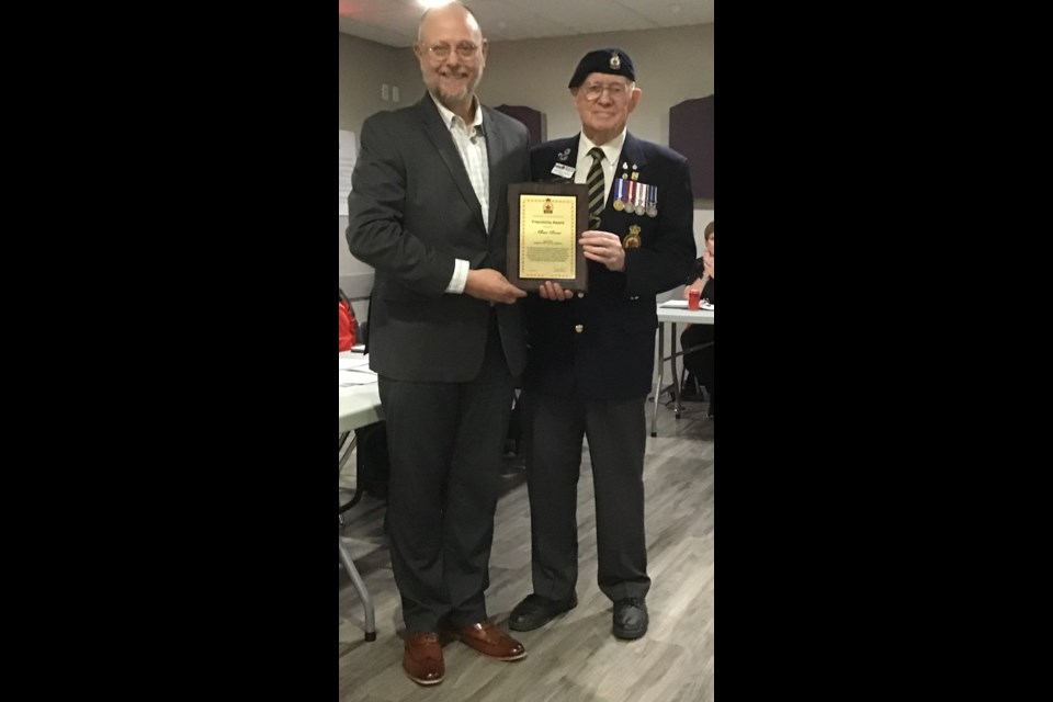 Allan Boss, left, receives a Legion Friendship Award from Okotoks Legion President Malcolm Hughes at the Elks Hall in Okotoks on Sept. 12.