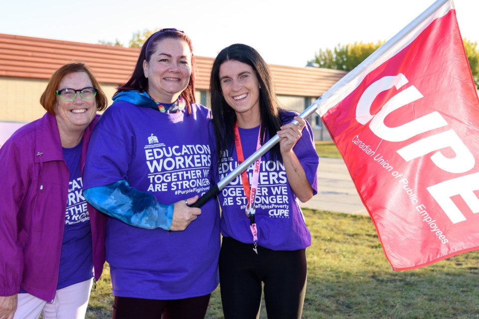 Education support workers Sheila Corbett, left, Kari Edwards, centre, and Emily Rawson, at a day of action for education support workers near École Joe Clark School in High River on Sept. 20.