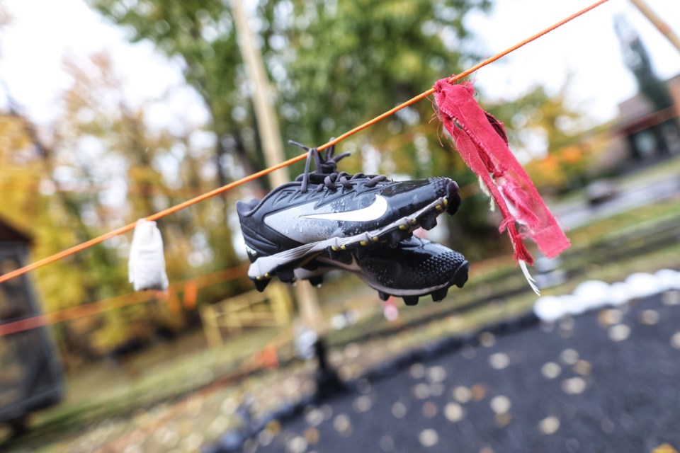 Ribbons, shoes, and other offerings hang from a memorial site to victims and survivors of the Residential School System and Missing and Murdered Indigenous Women, set up at Ethel Tucker Park for the National Day for Truth and Reconciliation on Sept. 30.