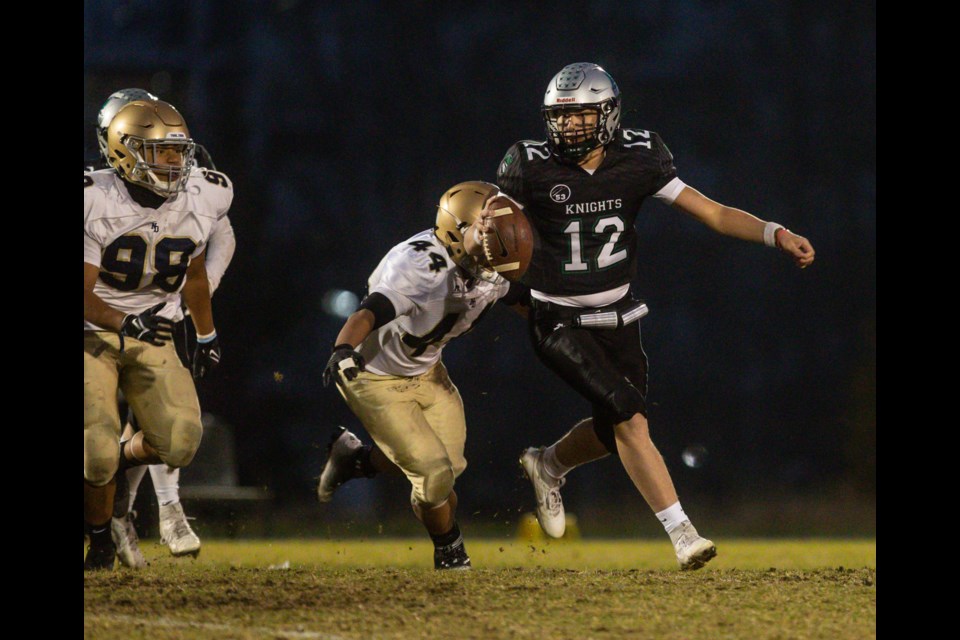 HTA Knight Declan Lyth is pursued by the Notre Dame Pride defensive line at Holy Trinity's field on Oct. 12.