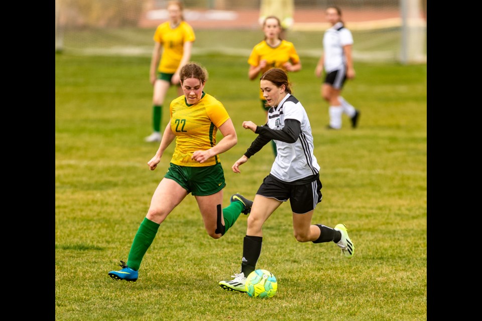 HTA Knight Eva Gustafson tries to dodge a Canmore Collegiate Wolverine at Bill Robertson Park in Okotoks on Oct. 11.