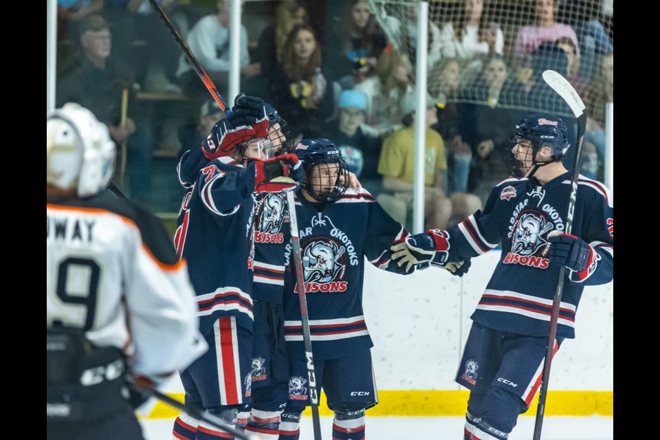 Carstar Okotoks Bisons forward Owen McFarlane, middle, celebrates his first goal with the squad with teammates Seamus Garagan, Adam Kirkpatrick and Trevor Bonham during the 4-1 victory over the Coaldale Copperheads in HJHL action on Oct. 20 at the Murray Arena.