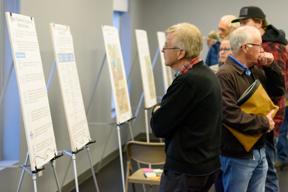 Members of the public look at information boards during an open house at the Cavalry FC Regional Field House in Foothills County for Joint Planning Area 3 on Nov. 2.