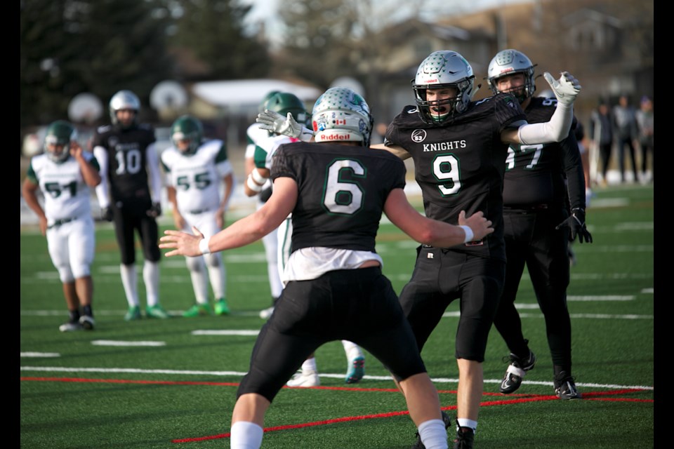 Holy Trinity Academy Knights defensive lineman Ben Haden (6) celebrates his quarterback sack with teammate Xavier Krueger (9) during the 40-0 win over the Springbank Phoenix. 