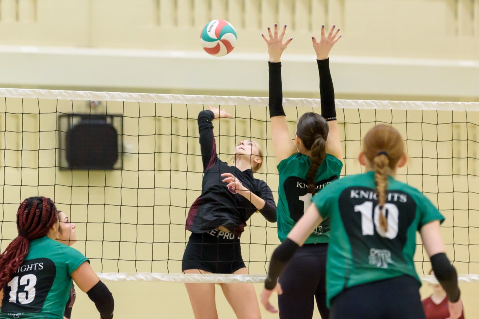 Holly Fitzner of the Foothills Falcons looks to evade the Holy Trinity Academy Knights blockers in the league final on Nov. 6.