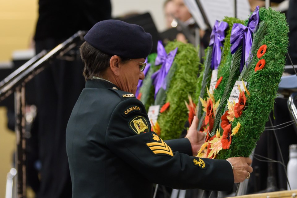 Donna Friesen lays a wreath on the stage during the Remembrance Day Service at Oilfields School in Diamond Valley on Nov. 11.