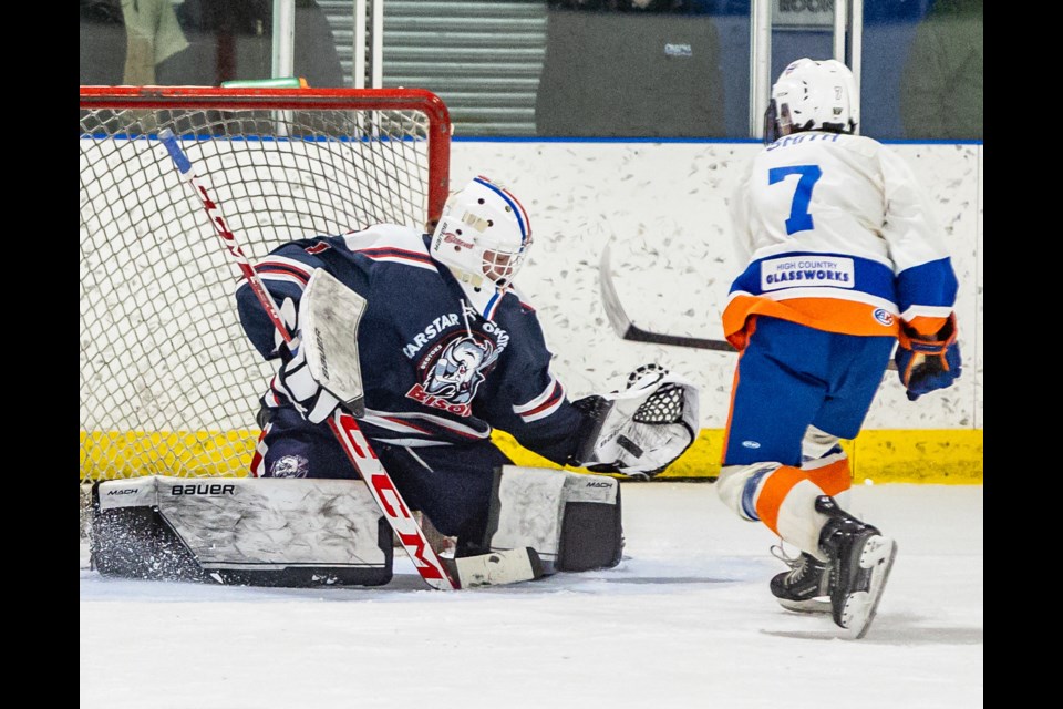 Carstar Okotoks Bisons goalie Grady Nicholas makes a game-winning overtime save against the High River Brewing Co. Flyers' Connor Smith at Murray Arena on Nov. 25.