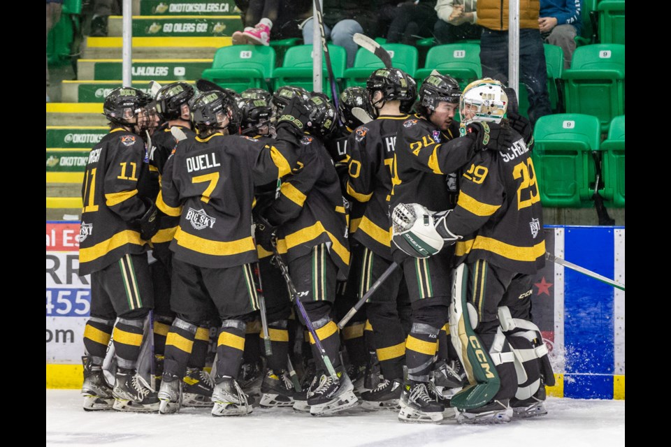 The Okotoks Oilers celebrate their 5-4 overtime victory over the Sherwood Park Crusaders on Nov. 25 at the Okotoks Centennial Arenas.