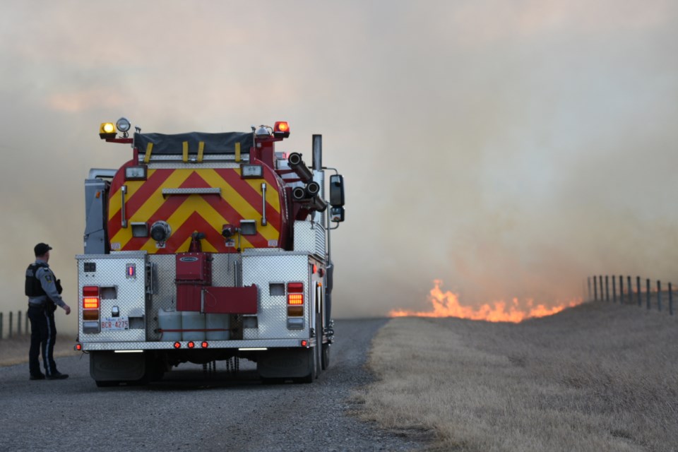 Emergency crews on scene at a large grassfire near Hwy 549 and 128 Street West in Foothills County on Dec. 5.