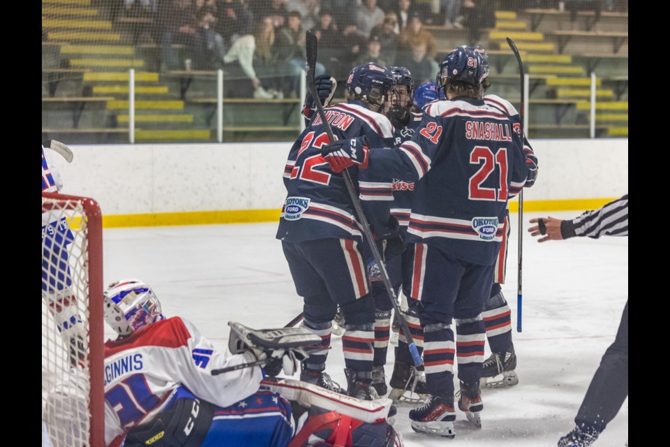 The Carstar Okotoks Bisons celebrate forward Daniel Tainton's goal on the Mountainview Colts at Murray Arena on Dec. 8.