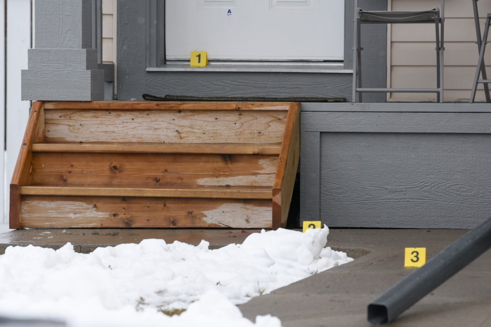 Evidence markers are seen near the front of a home following a shooting on Sheep River Court Okotoks on May 1. 