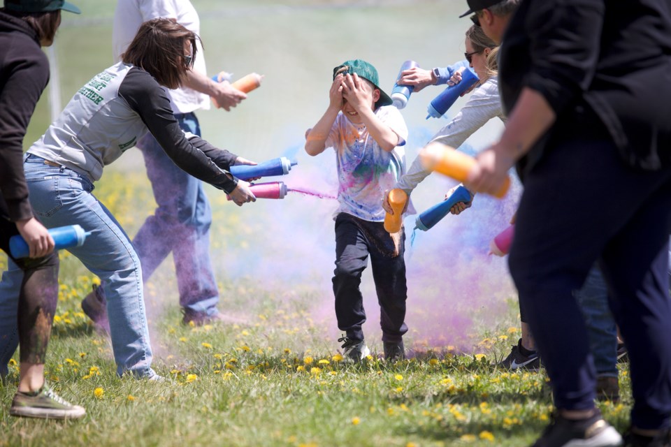 Parent volunteers spray colour all over Millarville Community School students participating in the Walkathon Colour Run on May 31. 