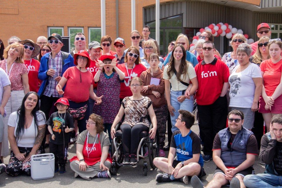 Foothills Advocacy in Motion Society staff, volunteers and clients pose at the ribbon cutting ceremony for the new Okotoks office on June 14.