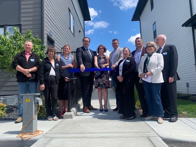 Okotoks Mayor Tanya Thorn is joined by ministers RJ Sigurdson and Jason Nixon as well as current and former board members of Westwinds Communities for the ribbon cutting at Drake Towns Affordable Housing Complex on June 20.