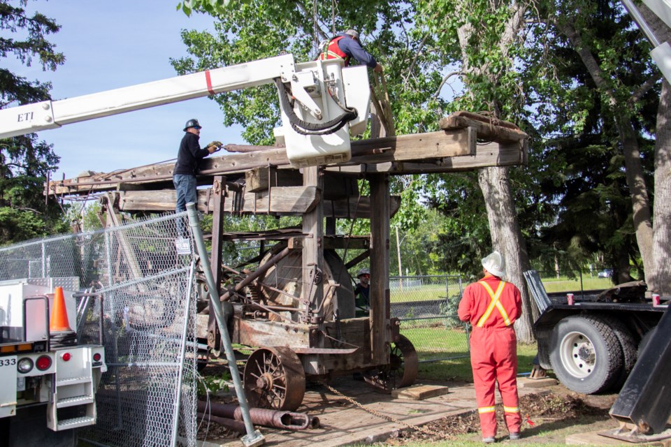 Okotoks' historic oil rig is prepared for transport on the morning of June 19.