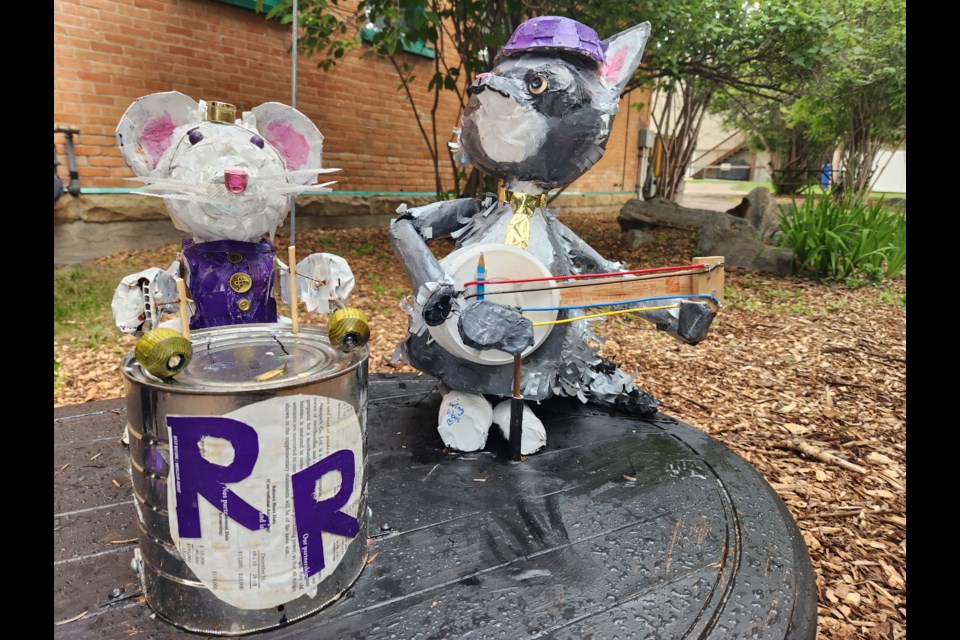 Ricky the Raccoon, on the right, at Stockton Garden on McRae Street in Okotoks on July 18. The raccoon has been reunited with band mates after being taken from an art installation made for the Nooks & Crannies Festival by Okotoks artist Jenny Dale Stables.