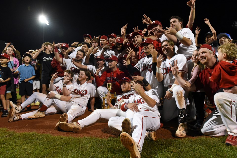 The Okotoks Dawgs celebrate after winning the Harry Hallis Trophy as WCBL champions following a 6-5 win over the Moose Jaw Miller Express in Game 3 of the best-of-three league final at Seaman Stadium in Okotoks on Aug. 17.