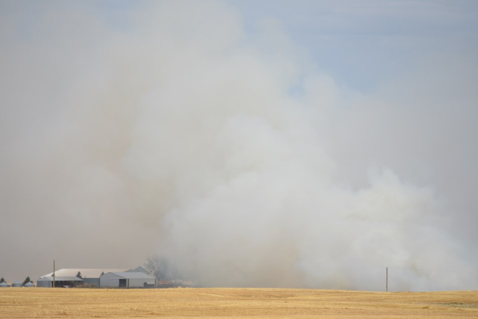 Smoke billows from a fire in Foothills County on Aug. 27.