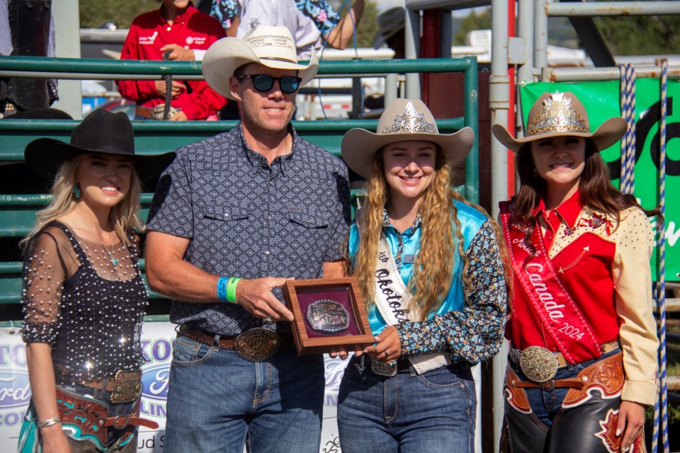 Newly-crowned Miss Rodeo Okotoks Grace LeFresne (second from right) is presented her buckle by Foothills MP John Barlow, alongside outgoing Miss Rodeo Okotoks Avery Moore (left) and Miss Rodeo Canada Kaylee Shantz during the Okotoks Pro Rodeo at the Millarville Racetrack on Aug. 25.