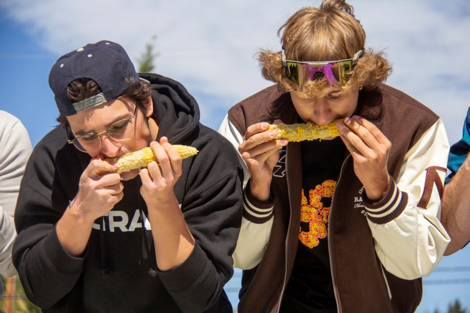 Ethan (left) and Winston Perpeluk chow down on cobs at the the Cobzilla Challenge, the Summer Round Up's corn-eating competition, in Okotoks on Aug. 24.