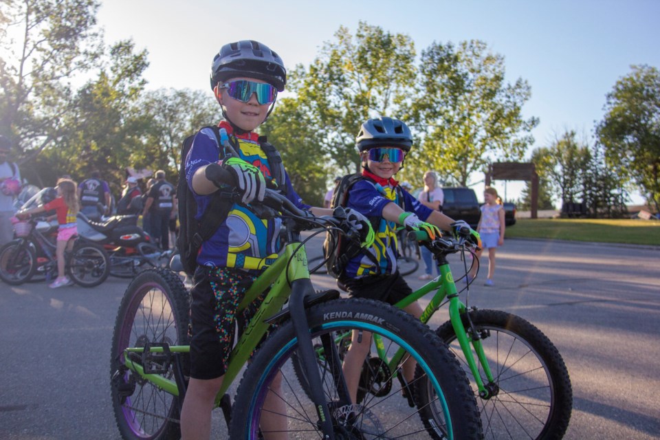 A parade including youngsters, emergency vehicles and members of Bikers Are Buddies Calgary rolled through Okotoks on Aug. 29 to raise funds and awareness for the fight against childhood cancer. The parade was led by Kolten (left) and Keegan Davis. 