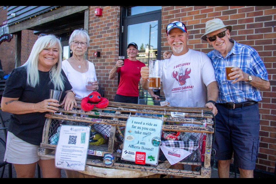 Lobster Quest organizers Karen (left) and Chris McCallum (second from right) celebrate Lucky the Lobster's arrival in Okotoks at Hub Town Brewing on Sept. 6, alongside Chris' parents Brian (right) and Marg (second from left).