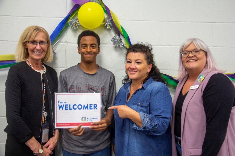 Town of Okotoks special project manager Janette Messer, (left), volunteer Isaac Brown, Foothills Community Immigrant Services  immigrant settlement coordinator Nancy Risdon and Okotoks Public Library director Sarah Gillie were at the Welcoming Week Social Gathering & Library Tour for Newcomers on Sept. 17 to welcome new Okotokians from across the country and world at the Okotoks Public Library.