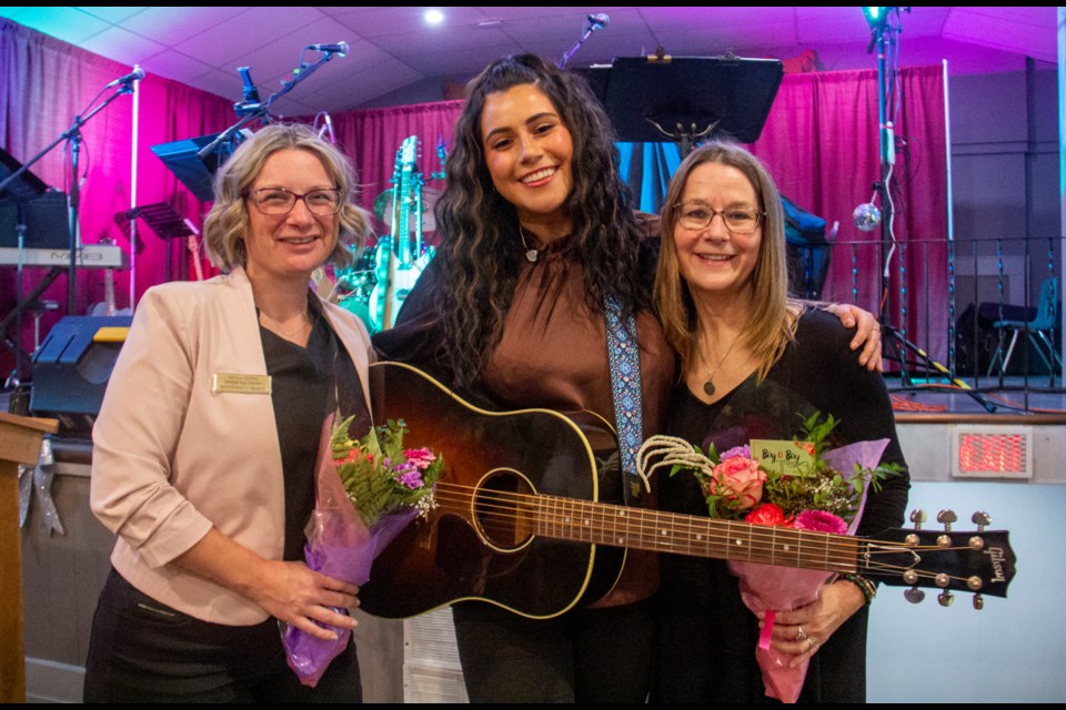 Rowan House Society community engagement team program lead Krystal Hoover (left) and executive director Linette Soldan (right) pose for a photo with singer Brettyn Rose during Rhythms for Rowan House at the Okotoks Elks Hall on Sept. 28.