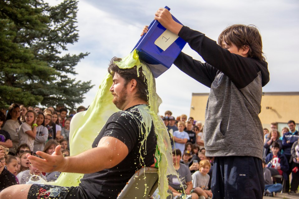 St. John Paul II Collegiate teacher Brenden Fleet gets "mystery soup" dumped on him by Noah Plouff at the school's Terry Fox Foundation fundraiser on Oct. 4. 