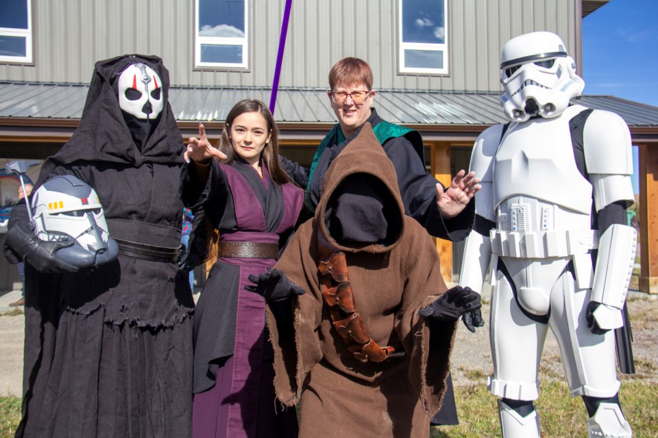 Members of The Dark Empire, 501st Legion and Rebel Legion came to Turner Valley on Oct. 5 for the Diamond Valley Sustainable Living Centre's one-year anniversary celebration and open house. From left: Deez Lees (Darth Nihilus), Courtney Wong (Sith Lord), Robin Beck (Sith Lord), Vicki Zaharichuk (Jawa) and TK-6038 (Imperial stormtrooper).