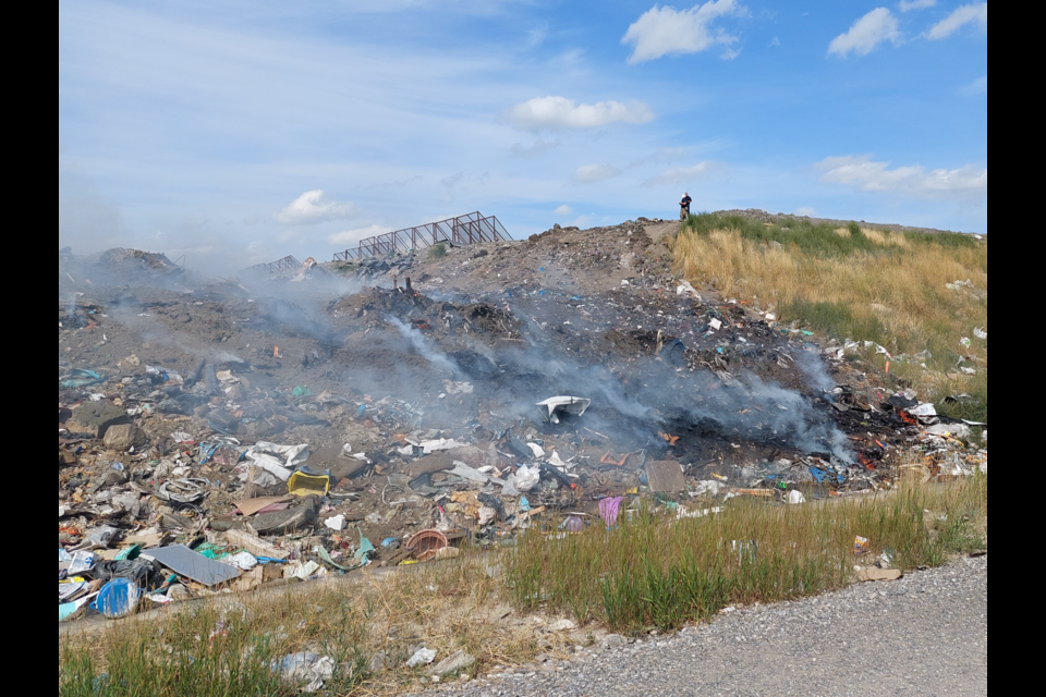 Smoke rises from a burned area after a fire at the Foothills Regional Landfill and Resource Recovery Centre in Foothills County on Aug. 22.