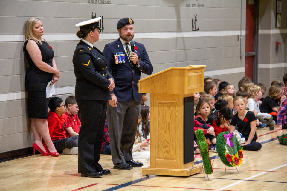 Sailor 2nd Class Janice Blasius (left) and former combat medic James Grant speak on the significance of Remembrance Day at St. Mary's School in Okotoks on Nov. 8.