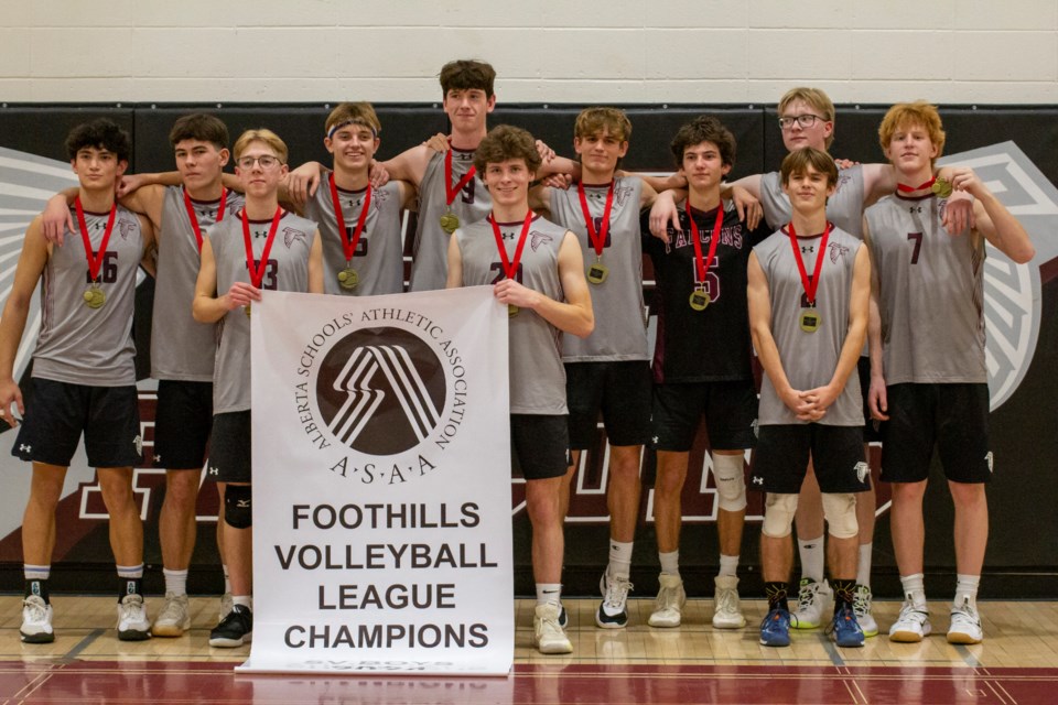 The Foothills Falcons pose with the Foothills Athletic Council senior boys volleyball banner after beating the Strathcona-Tweedsmuir School Spartans in the Foothills Composite High School gymnasium on Nov. 7.