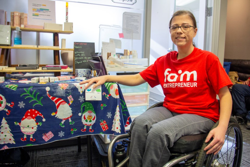 Foothills Advocacy in Motion Society (FAIM) entrepreneur Jessica Helm greets customers at FAIM's Christmas market and bake sale in Okotoks on Nov. 16.