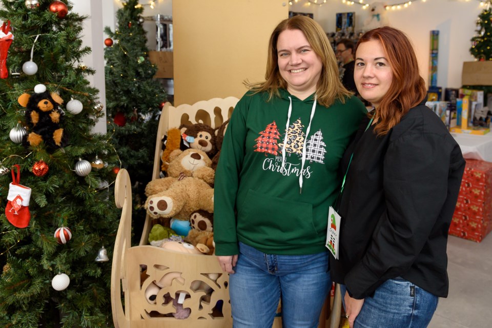 Lorna Jewer, left, director of MyCityCare Okotoks, and volunteer Stephanie Harland pose for a photo at the Shop of Wonders in Okotoks on Dec. 11.