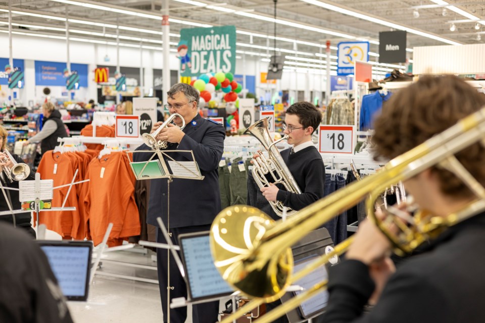 The Salvation Army's Glenmore Temple Band, composed of volunteer musicians, performs at Walmart in Okotoks on Dec. 14.