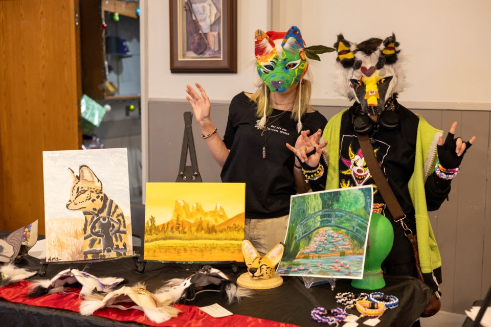 Amelie Agnew (left) and Glory Skrzypczynski pose for a photo with their artwork at the Inspiration Studio's 13th annual youth art market in Okotoks on Dec. 14.