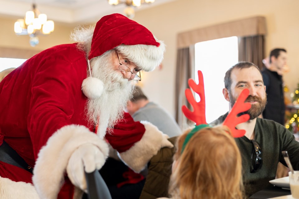 Santa Claus chats with supporters of Sheep River Health Trust during the organization's "Breakfast with Santa" fundraiser at the Best Western Plus Okotoks Inn & Suites on Dec. 14.