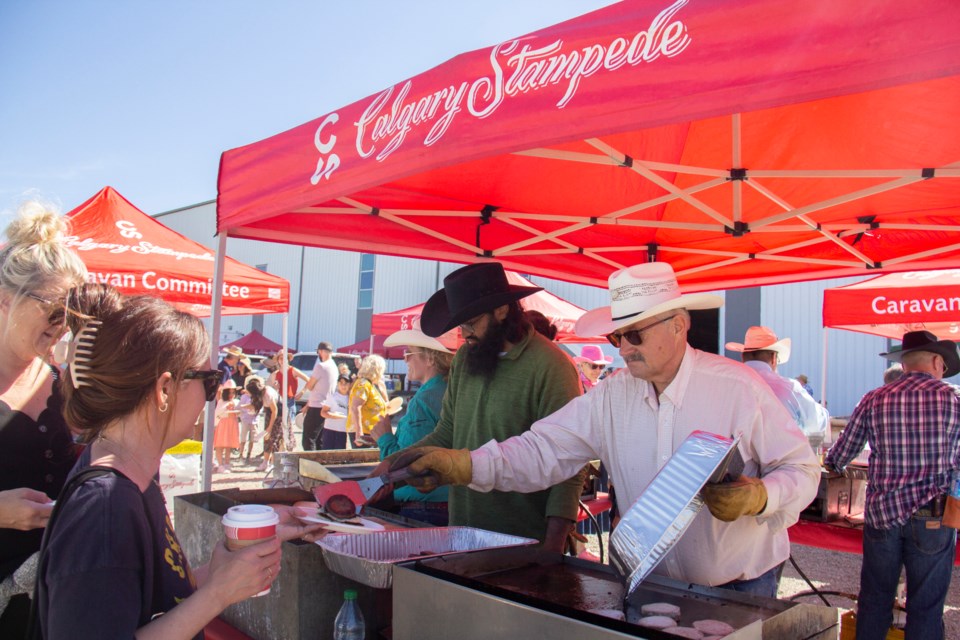 Calgary Stampede volunteers serve up pancakes during the third annual Foothills Family Expo on July 6 at the Cavalry FC Regional Field House.